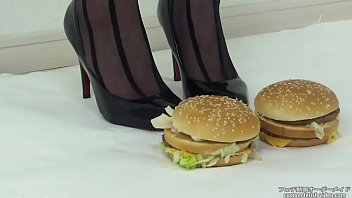 Foodcrush A woman steps on a hamburger with stockings