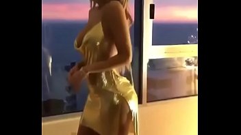 Sexy young girl is showing her sexy golden dress