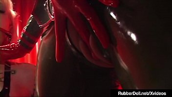 Busty Brunette Femdom Queen, RubberDoll, straddles her blonde prisoner's leg strapon & then penetrates her captive with a mechanical drill!