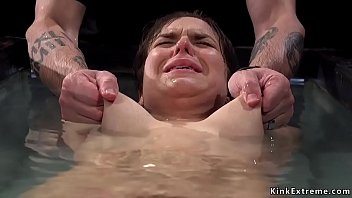 Brunette slut Juliette March in crotch rope with hands tied up above her head gets vibrated then master makes her suffering water bondage