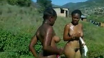 Africans girls bathing outdoors