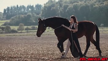 We meet pale all natural beauty Misha Cross walking with her massive steed upon a vast tract of farmland