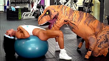 Hardbodied milf gets railed by a fucking dinosaur in a gym