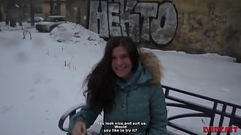 Tough Russian winter and beautiful girl sitting on the bench
