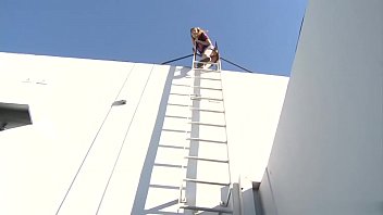 Naughty Nicole Ray fucks stud Bill Bailey on a building roof