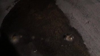 Young man piss then masturbates his long sex and have a cumshot over a wall in car-park