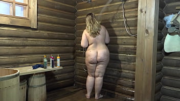 Chubby milf with a juicy PAWG washes in the shower and with a wide bottle fucks her hairy cunt and showing big vagina