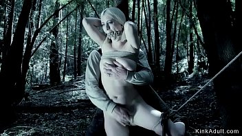 Hot busty blonde tied up between trees and gagged and pussy fingered